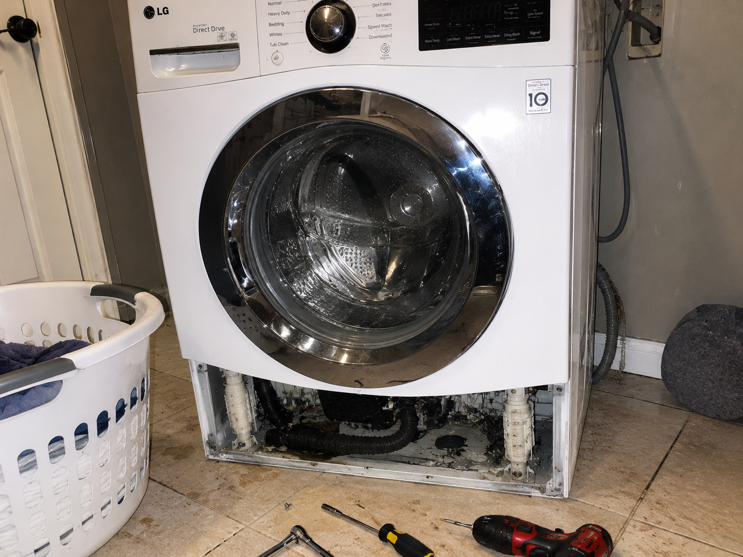 Professional replacing shock absorbers on a front-load LG washing machine.